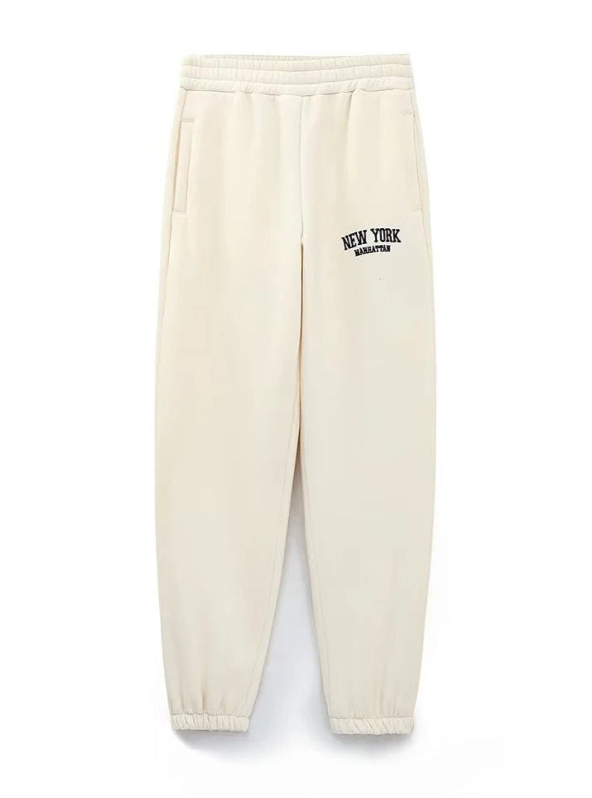 Beige sweatpants with 'New York' text on a white background