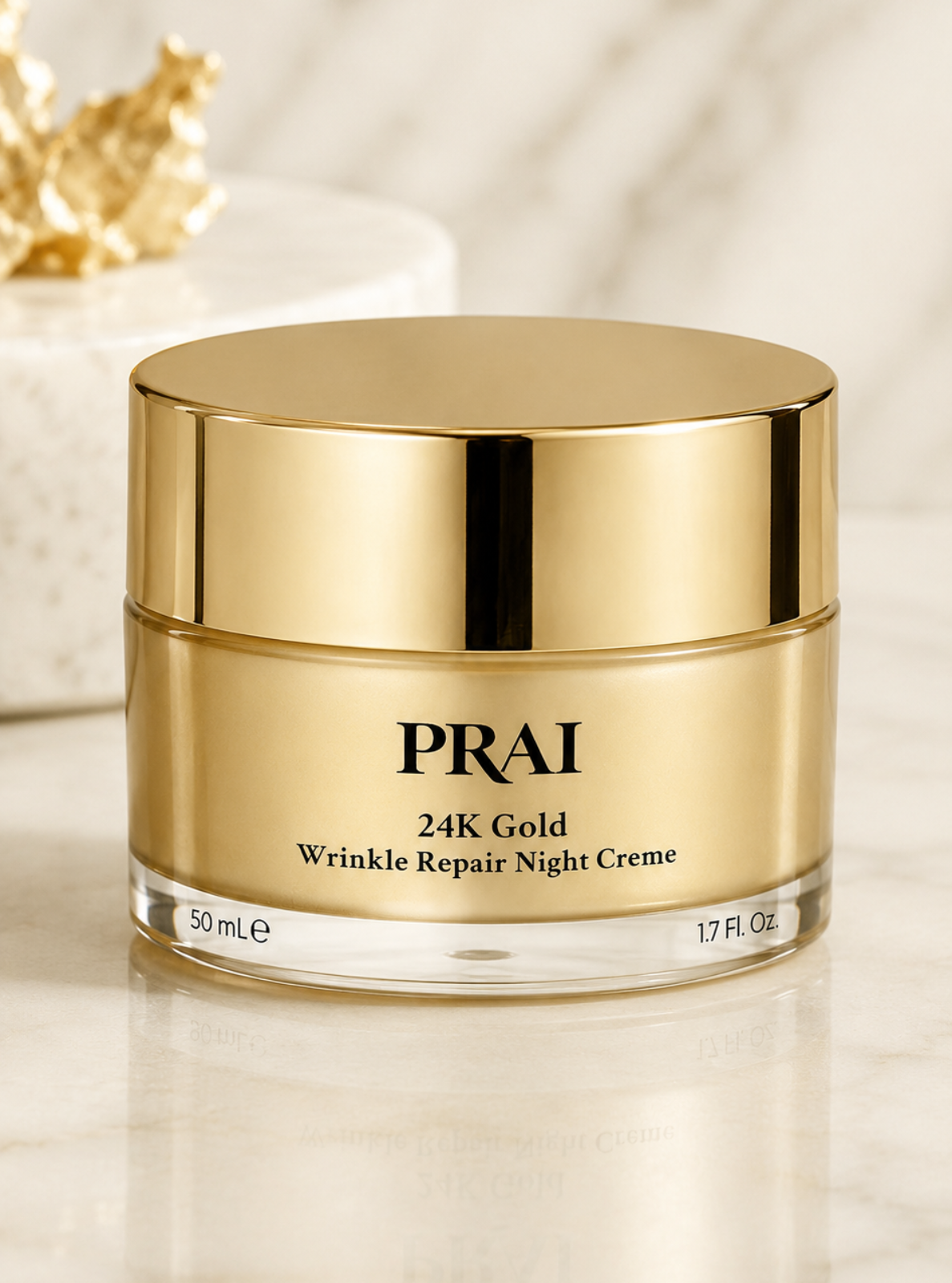 PRAI 24K Gold Wrinkle Repair Night Creme in a 50 mL jar with a shiny gold lid and gold label, set on a marble surface with a gold decorative object in the background.