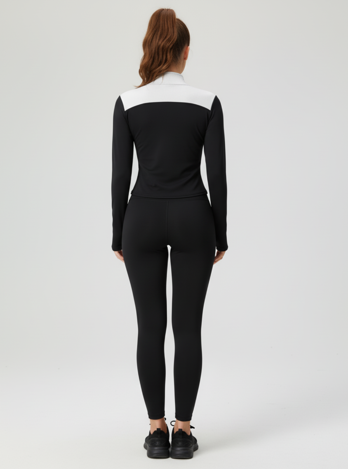 Person wearing a black and white outfit on a white background