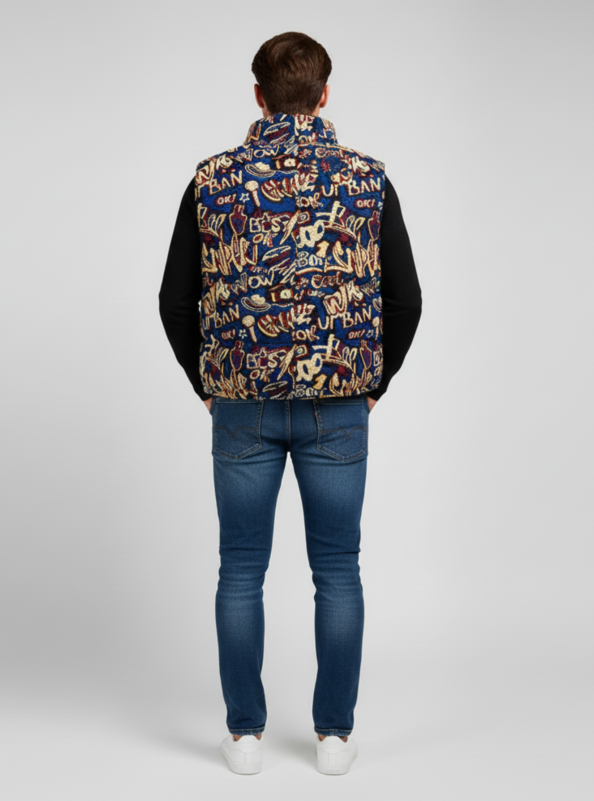 Person wearing a patterned jacket and jeans on a white background