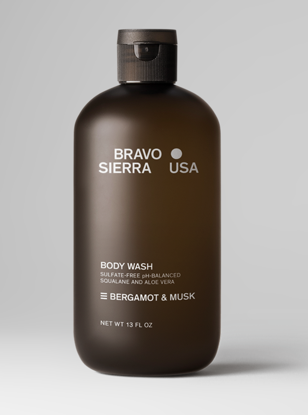 Brown bottle of Bravo Sierra body wash on a gray background