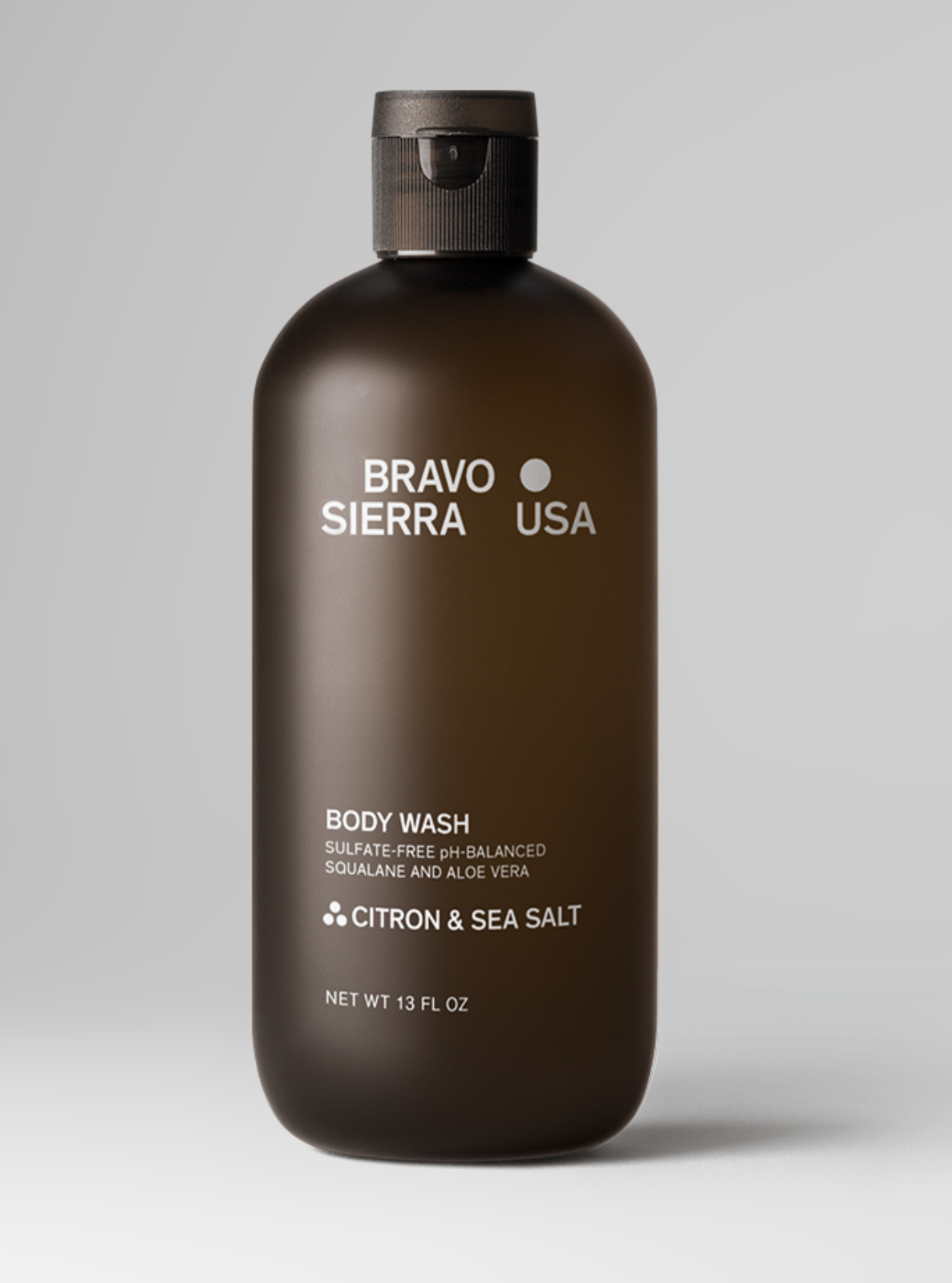 Brown bottle of Bravo Sierra body wash on a gray background