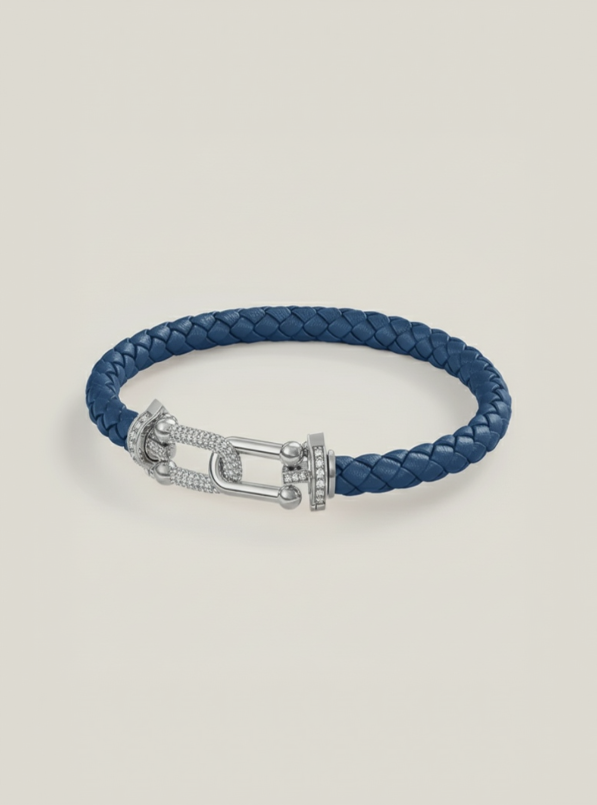 Blue braided leather bracelet with a silver clasp on a light gray background