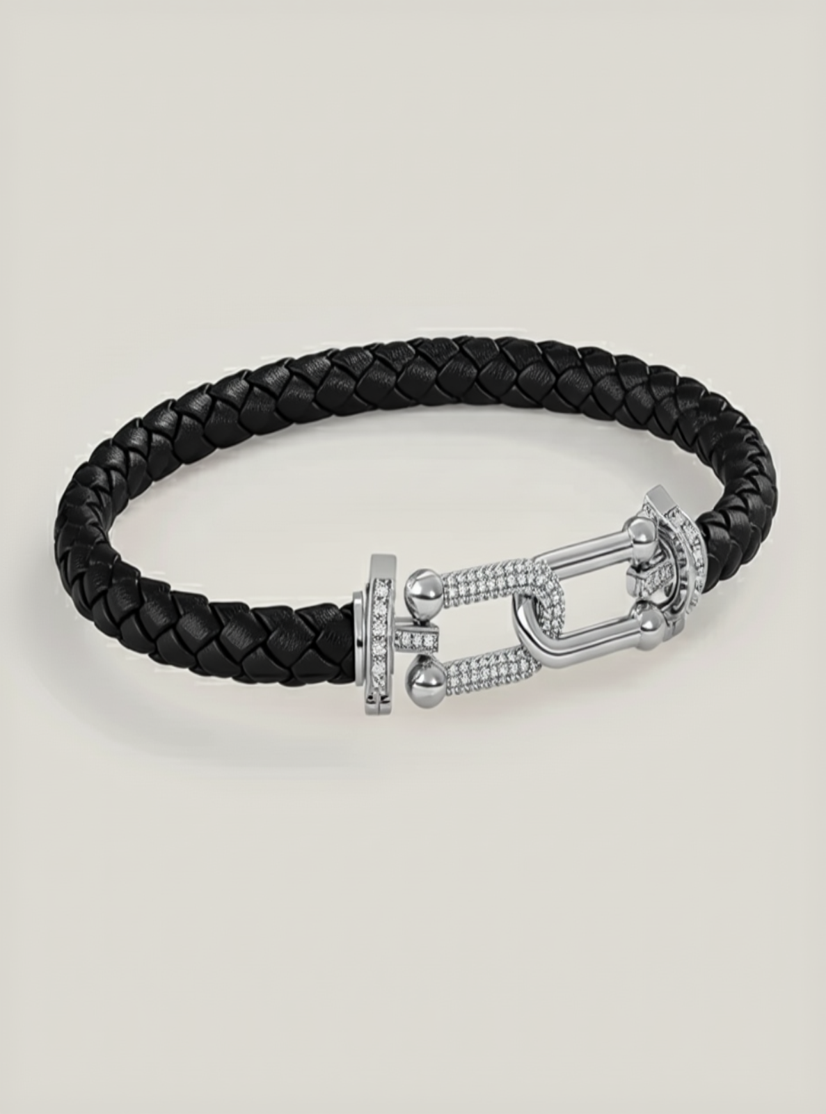Black braided leather bracelet with a silver clasp on a light gray background