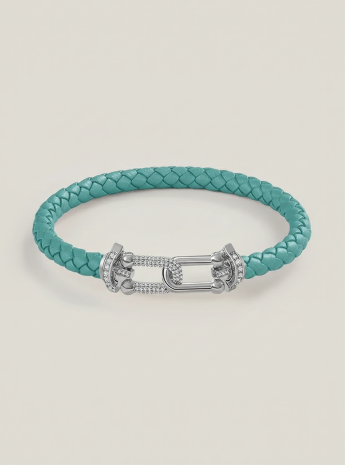 Turquoise braided bracelet with a silver clasp on a light gray background