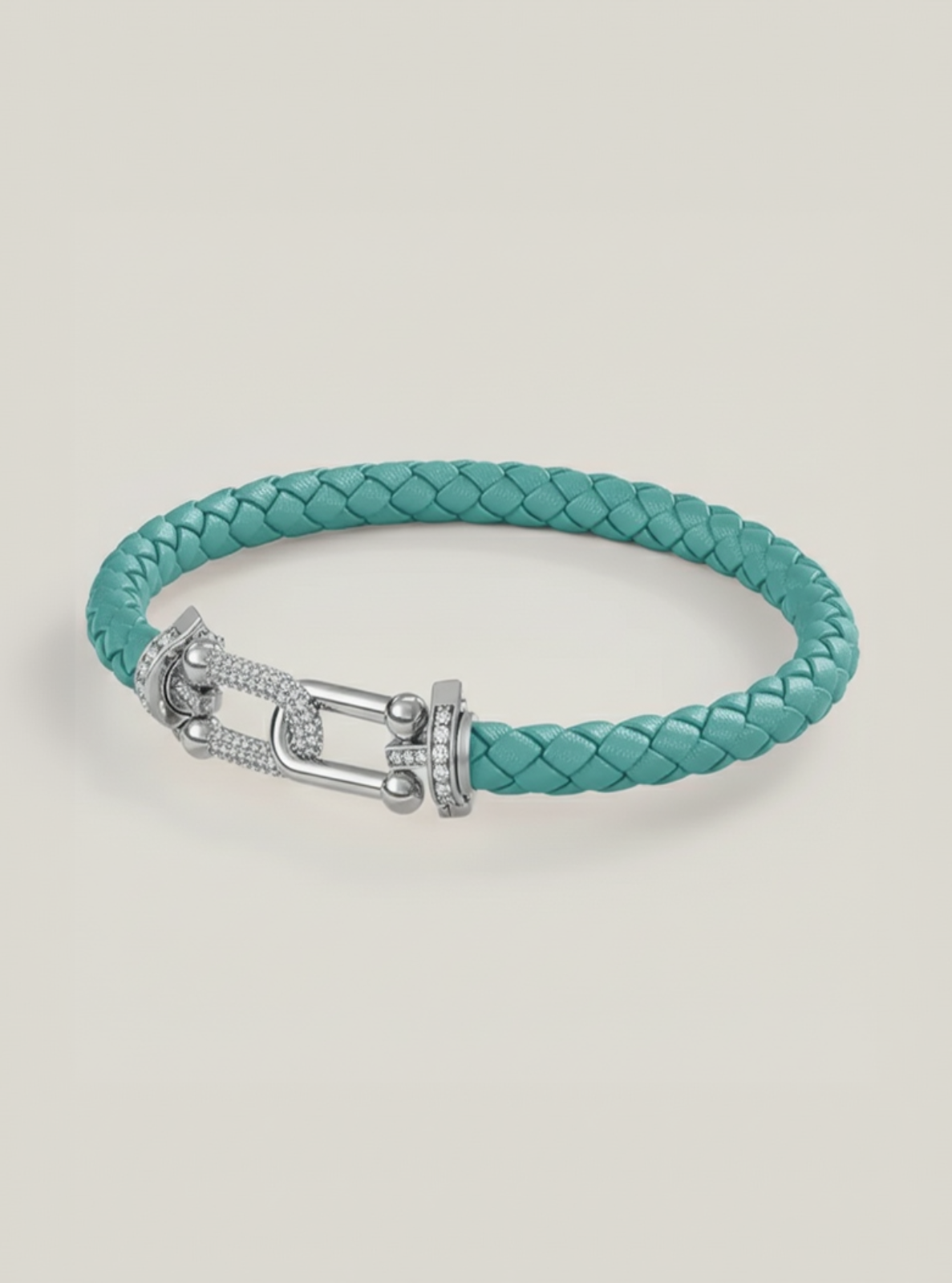 Turquoise braided bracelet with a silver clasp on a light gray background