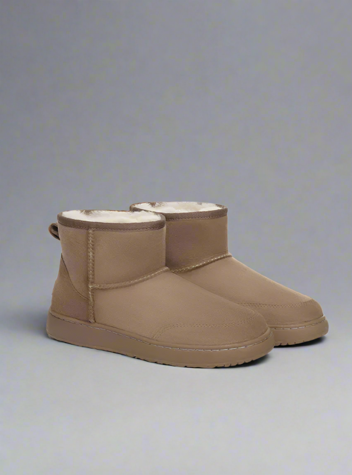 Pair of brown UGG boots on a white background