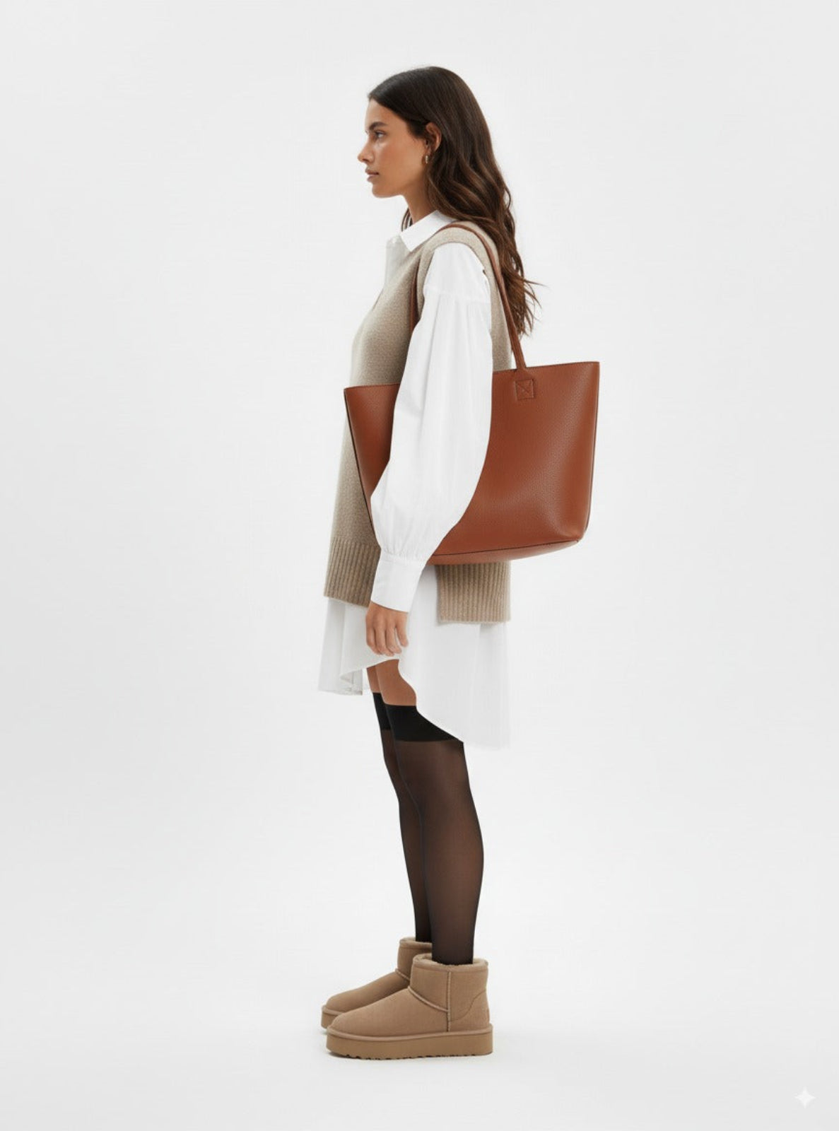 Woman holding a brown tote bag on a white background
