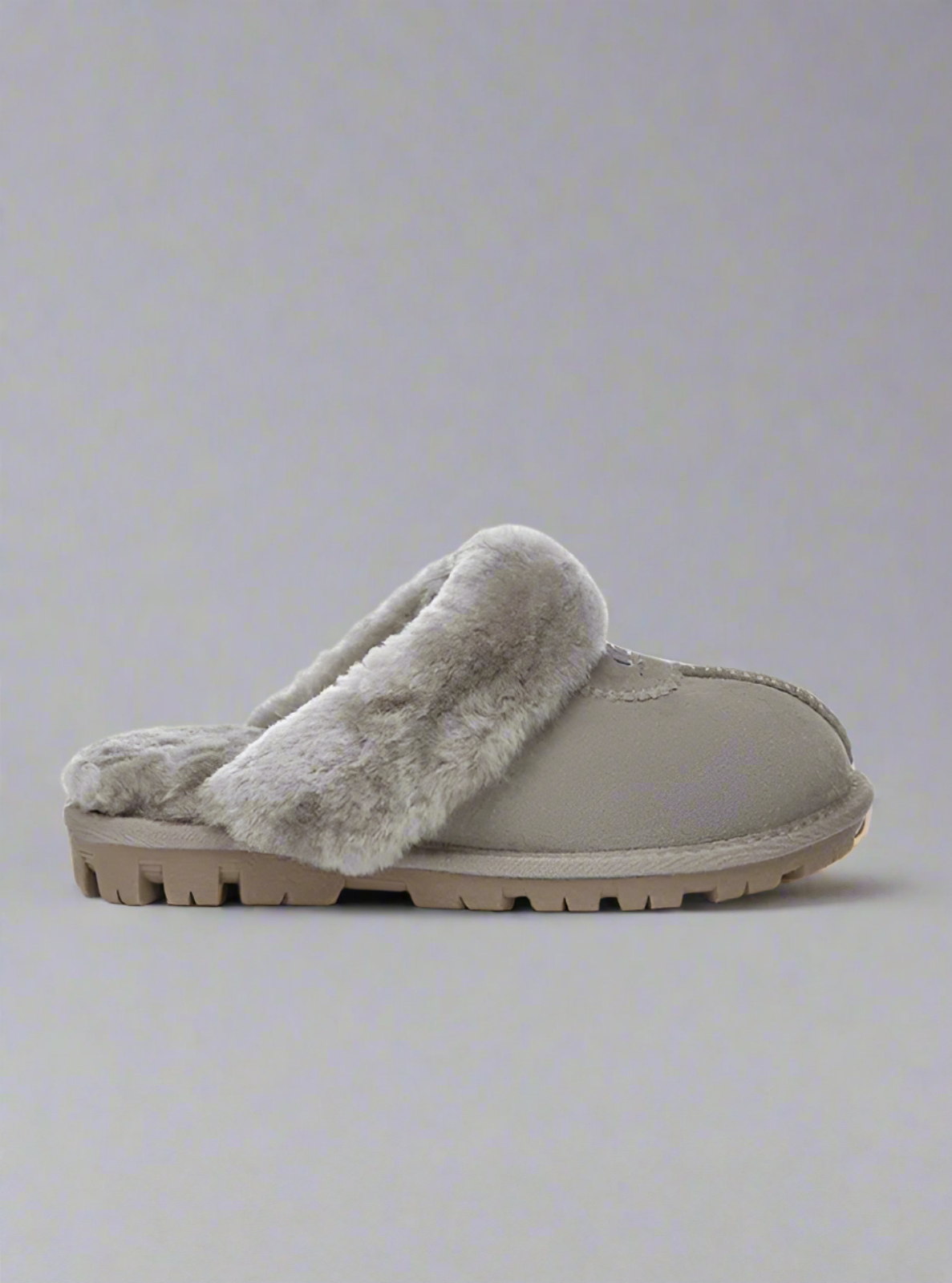 Gray slipper with fuzzy texture on a light gray background