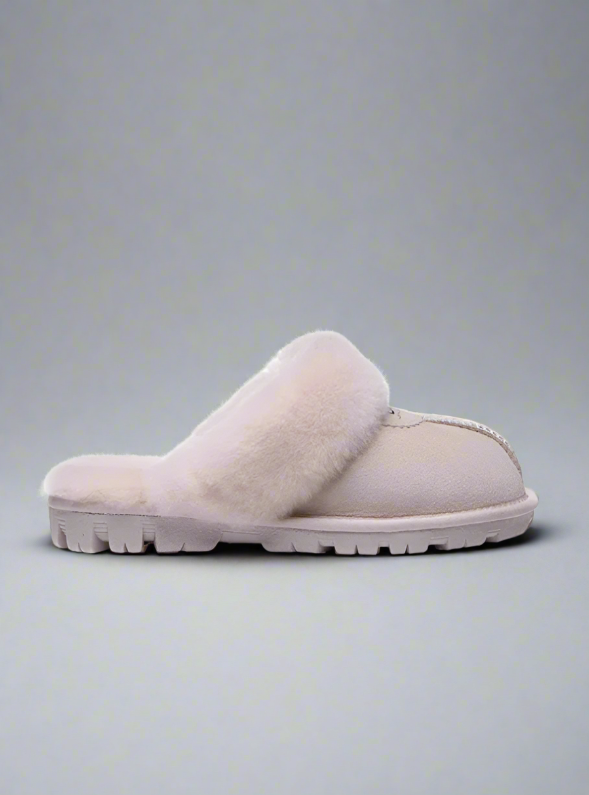 Beige slipper on a white background