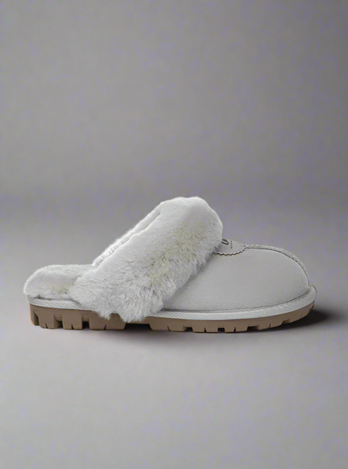 Gray slipper with fur lining on a white background