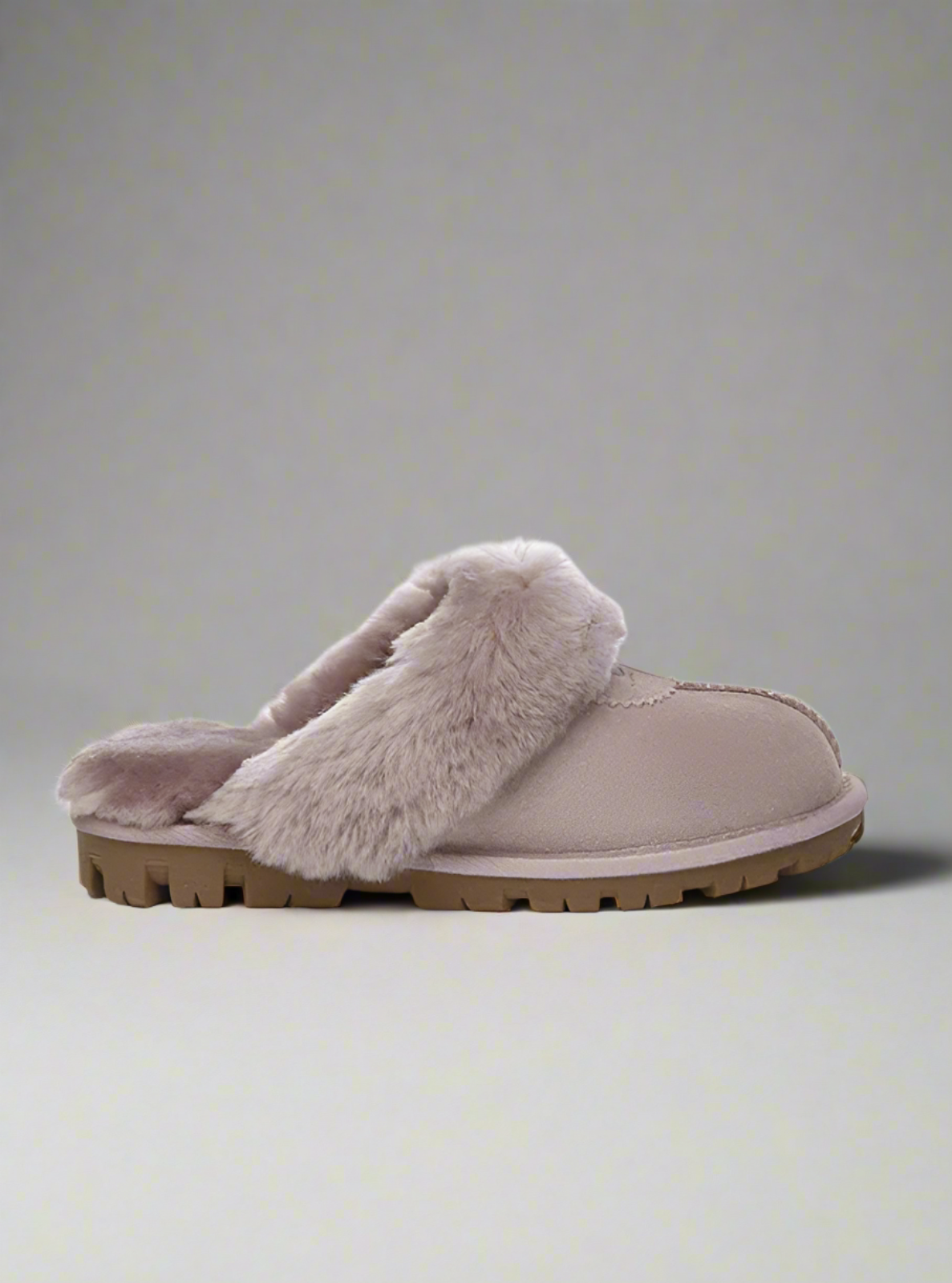 Gray slipper with fuzzy interior on a white background