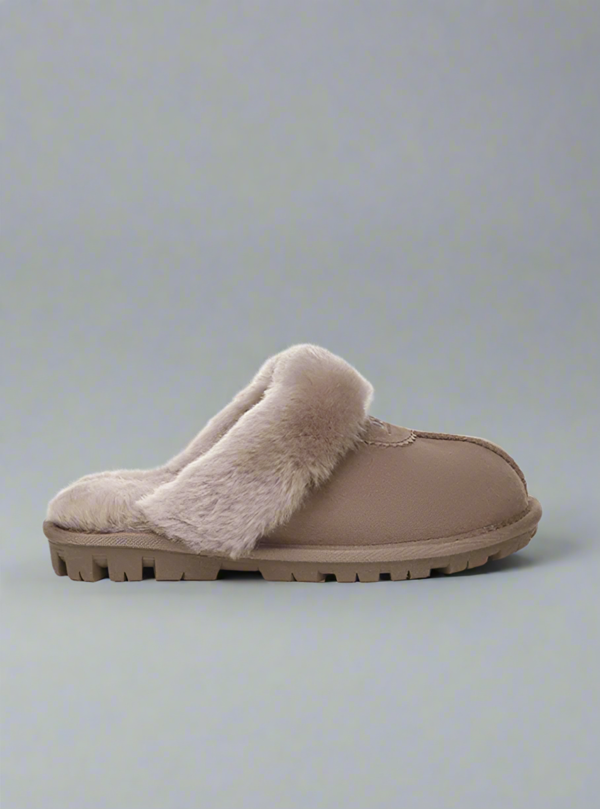 Beige slipper with fur trim on a light gray background
