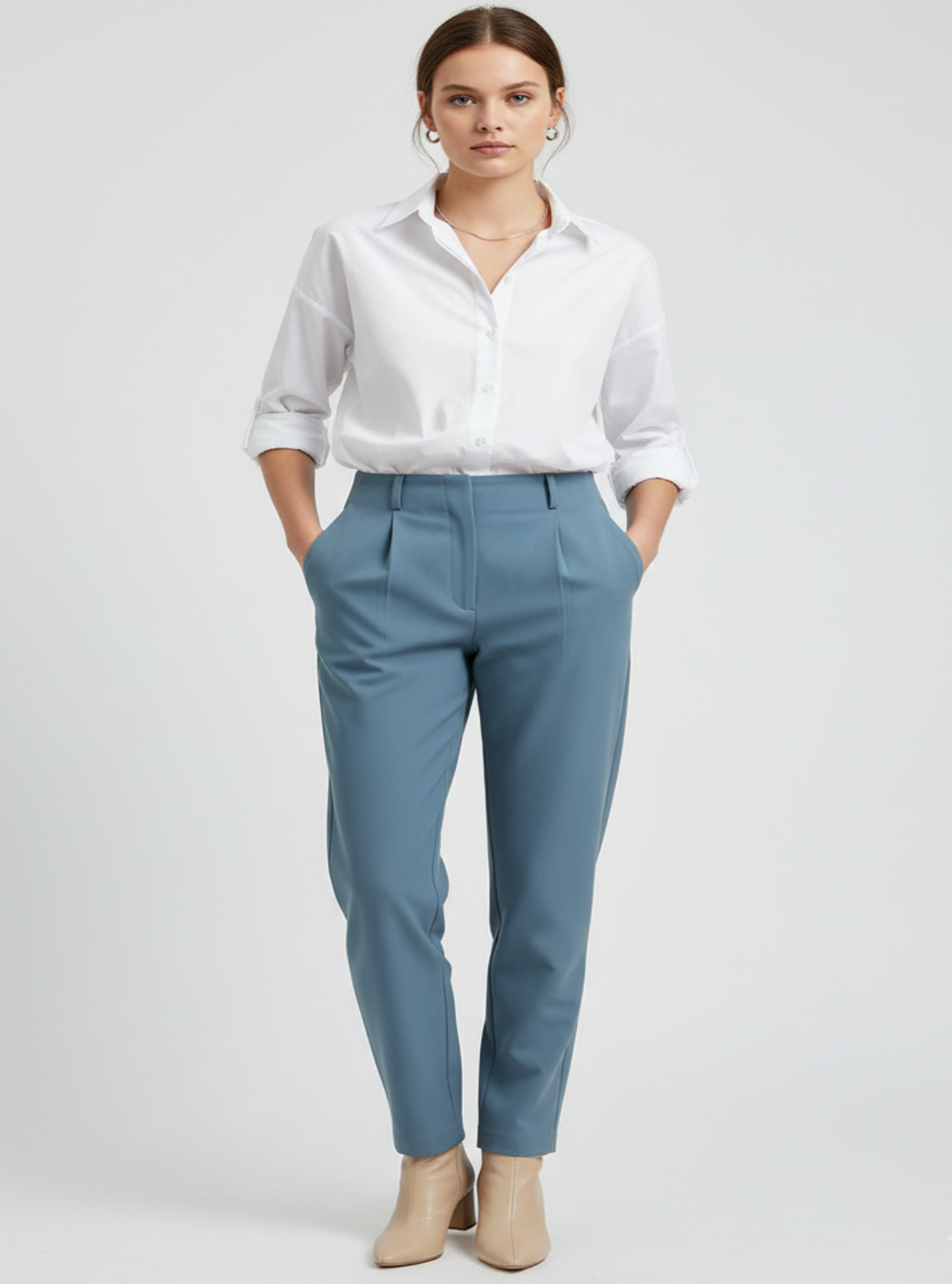 Person wearing a white shirt and blue pants on a light gray background