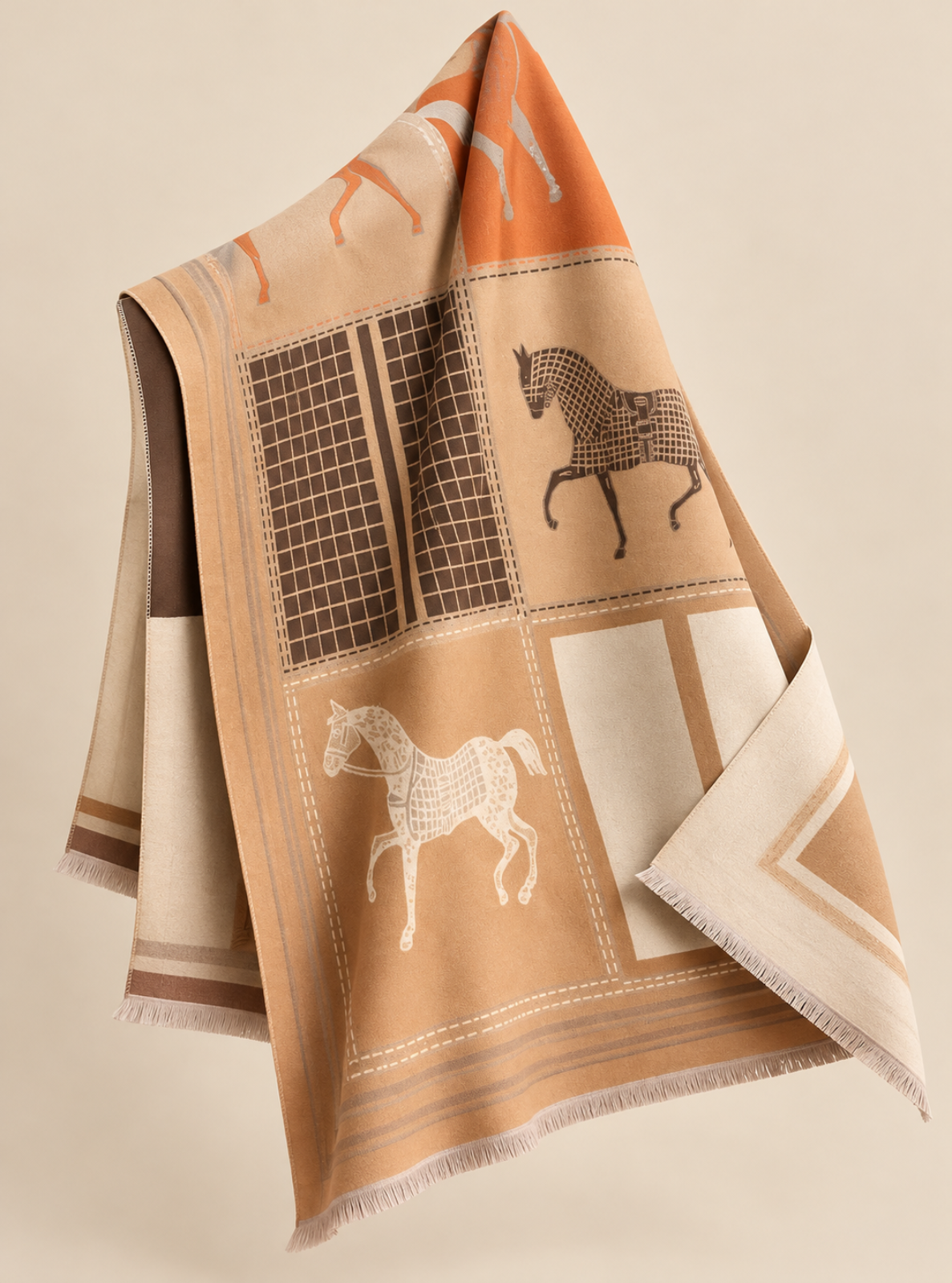 A beige and orange woven throw blanket with horse motifs, draped elegantly against a solid beige background.