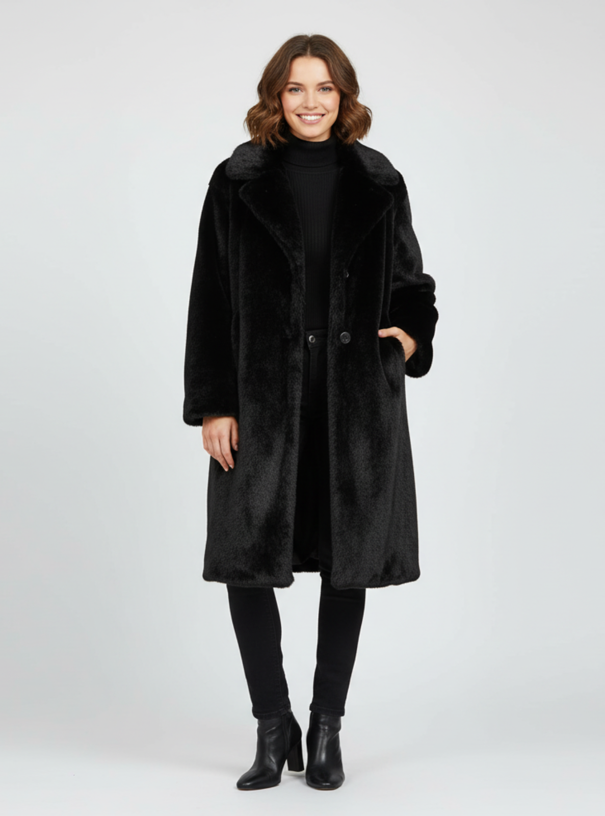 Woman wearing a black coat on a white background