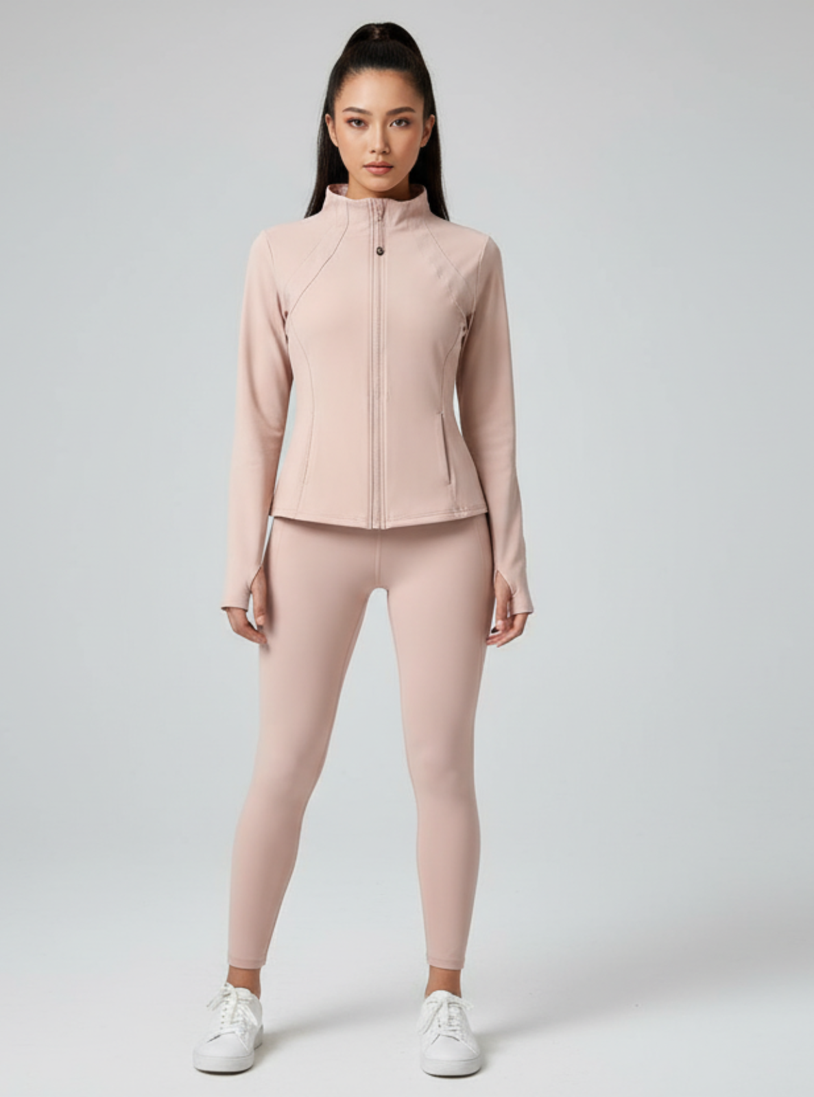 Woman wearing a pink athletic outfit on a white background