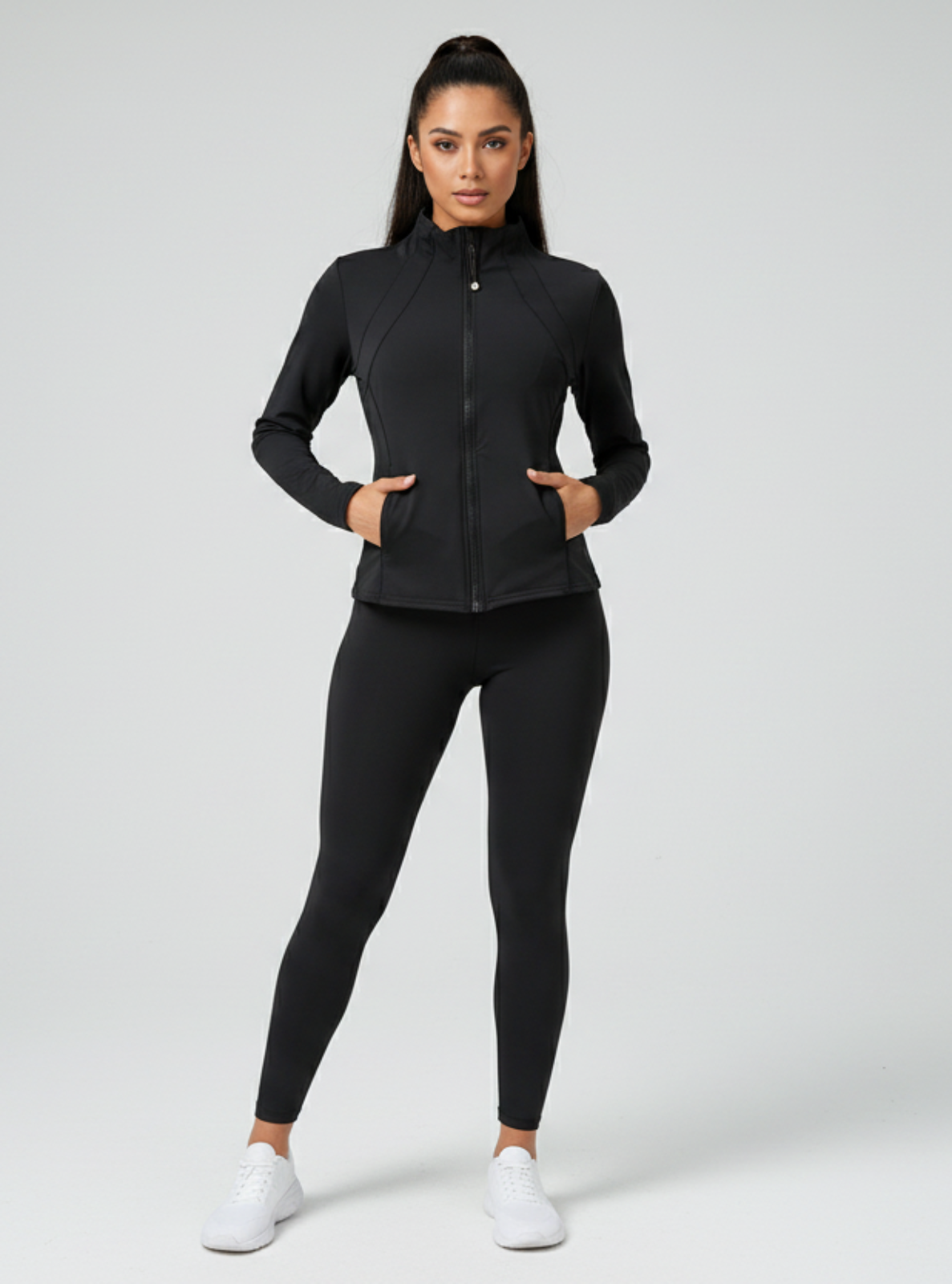 Woman wearing a black athletic outfit on a white background