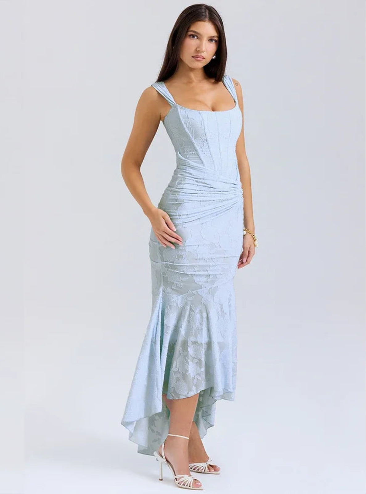 Woman wearing a light blue dress on a white background