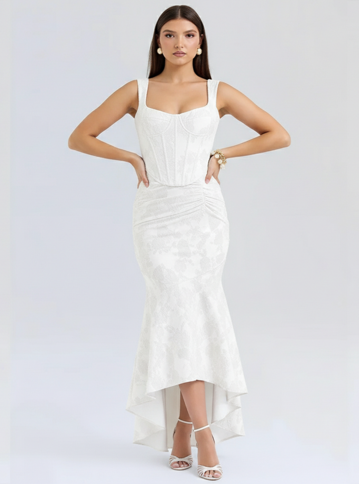 Woman wearing a white dress on a light gray background