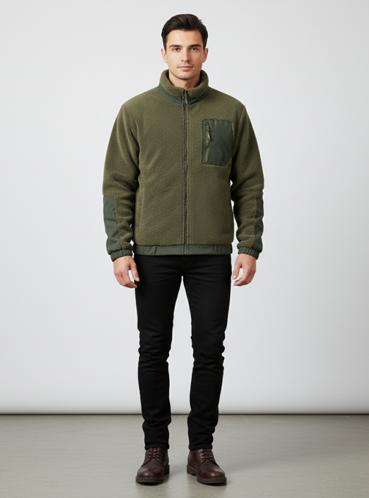 Man wearing a green jacket and black pants on a white background