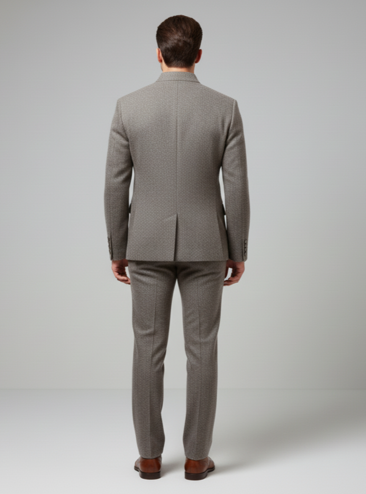 Man wearing a gray suit on a plain background