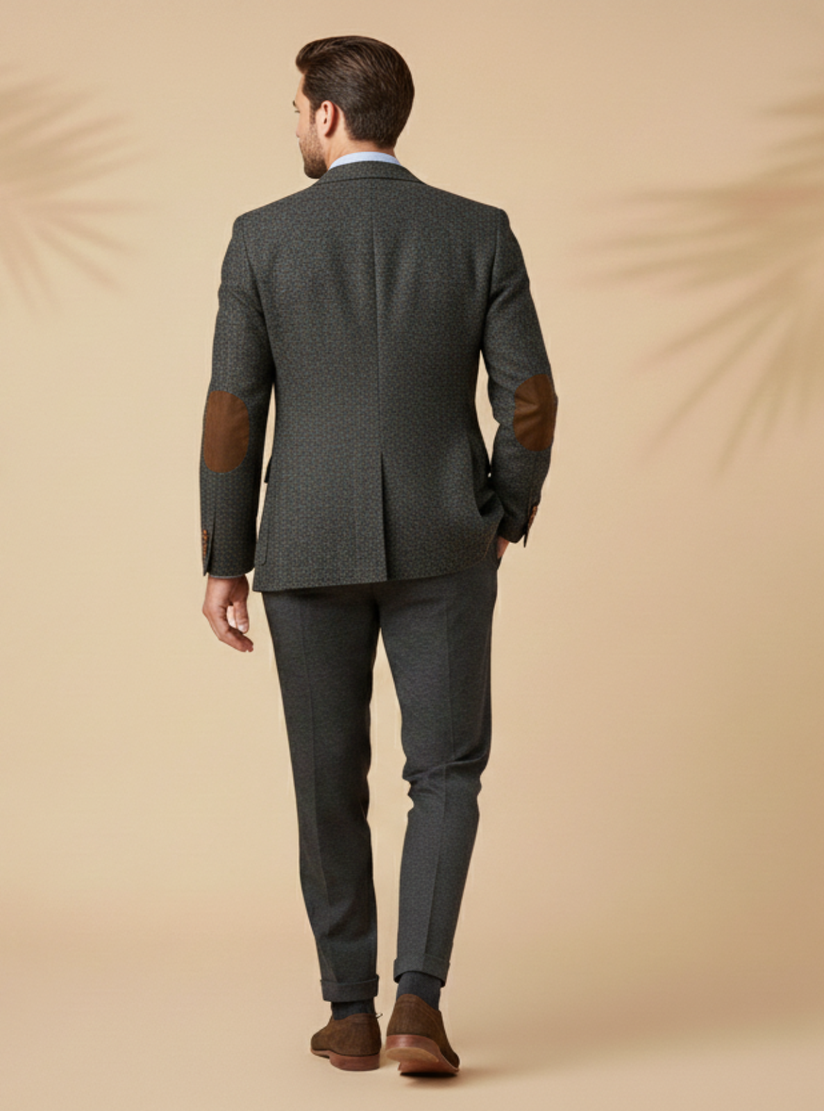 Man wearing a gray suit with brown accents on a beige background