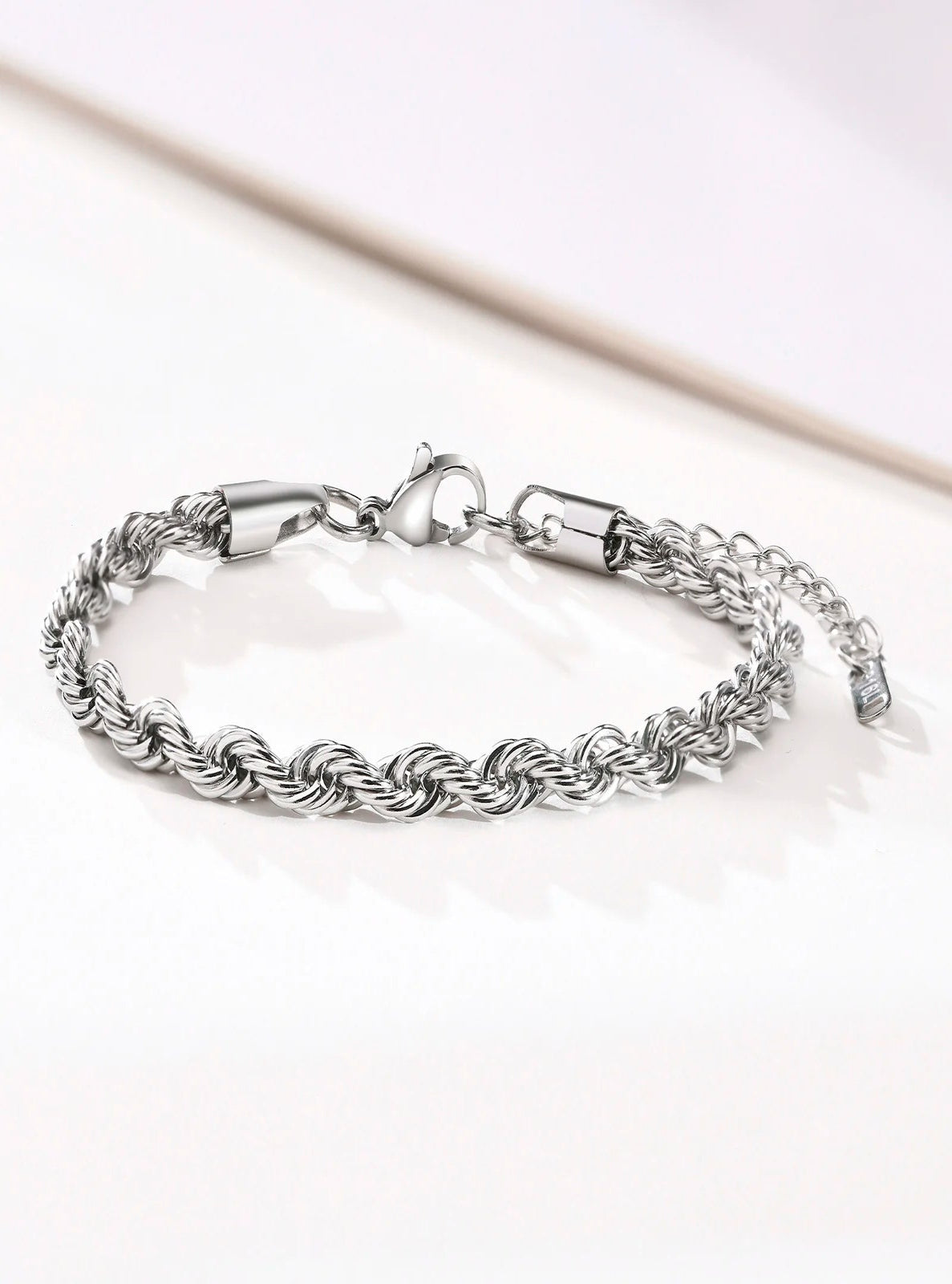 Silver braided bracelet on a white background
