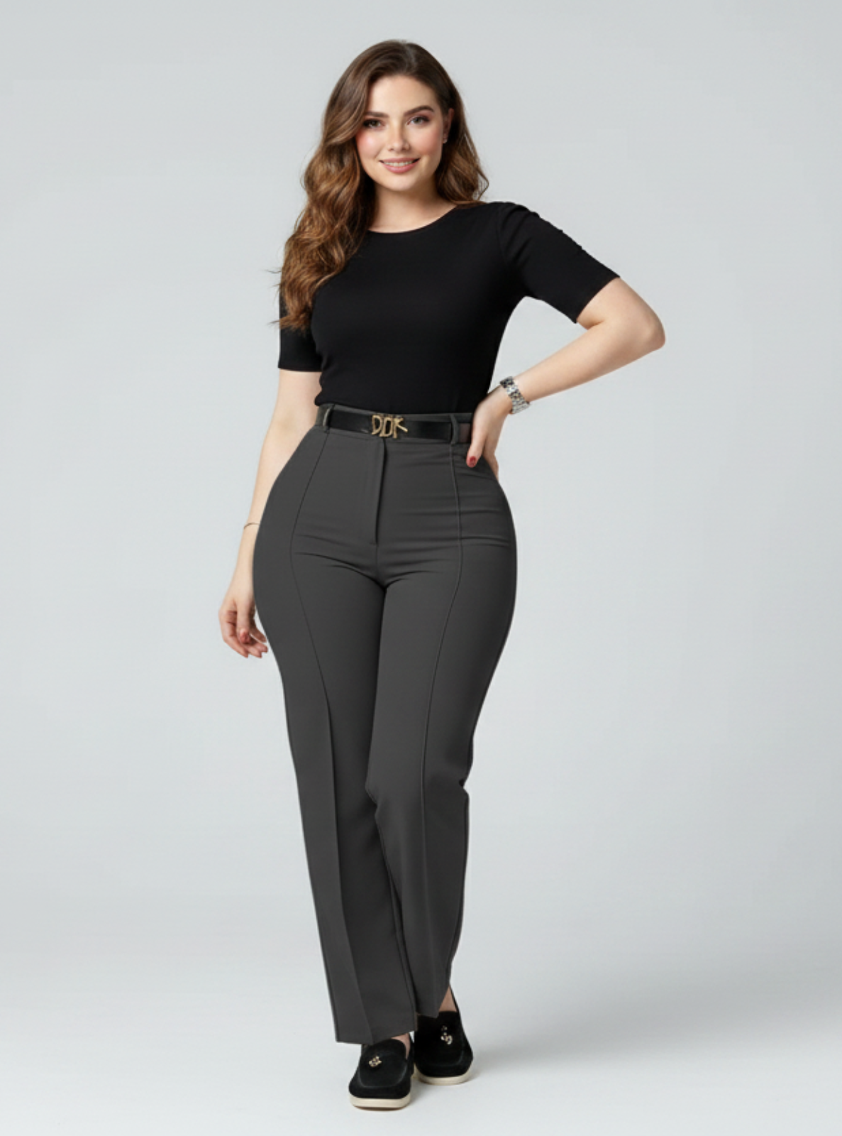 Woman wearing a black top and gray pants on a white background