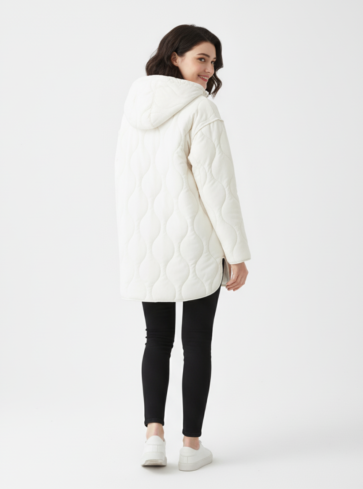 Woman wearing a white quilted jacket on a white background