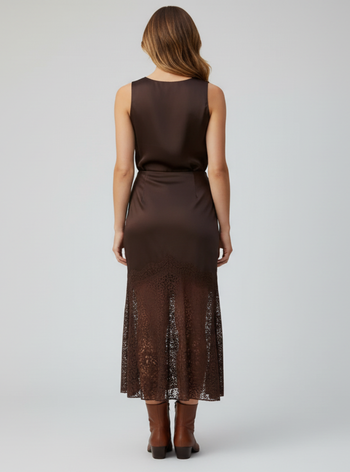 Woman wearing a brown sleeveless dress on a white background