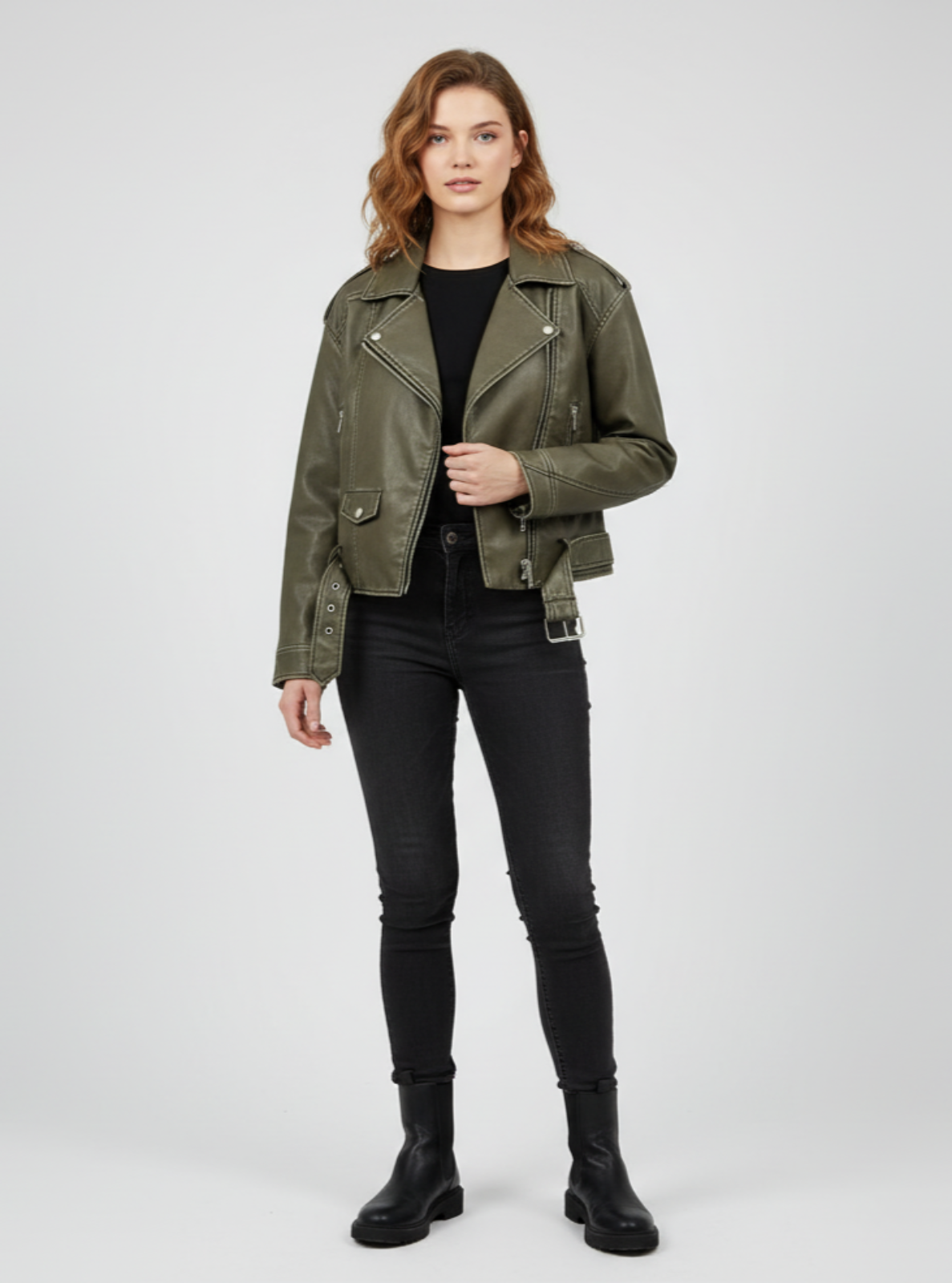 Woman wearing a green jacket and black pants on a white background