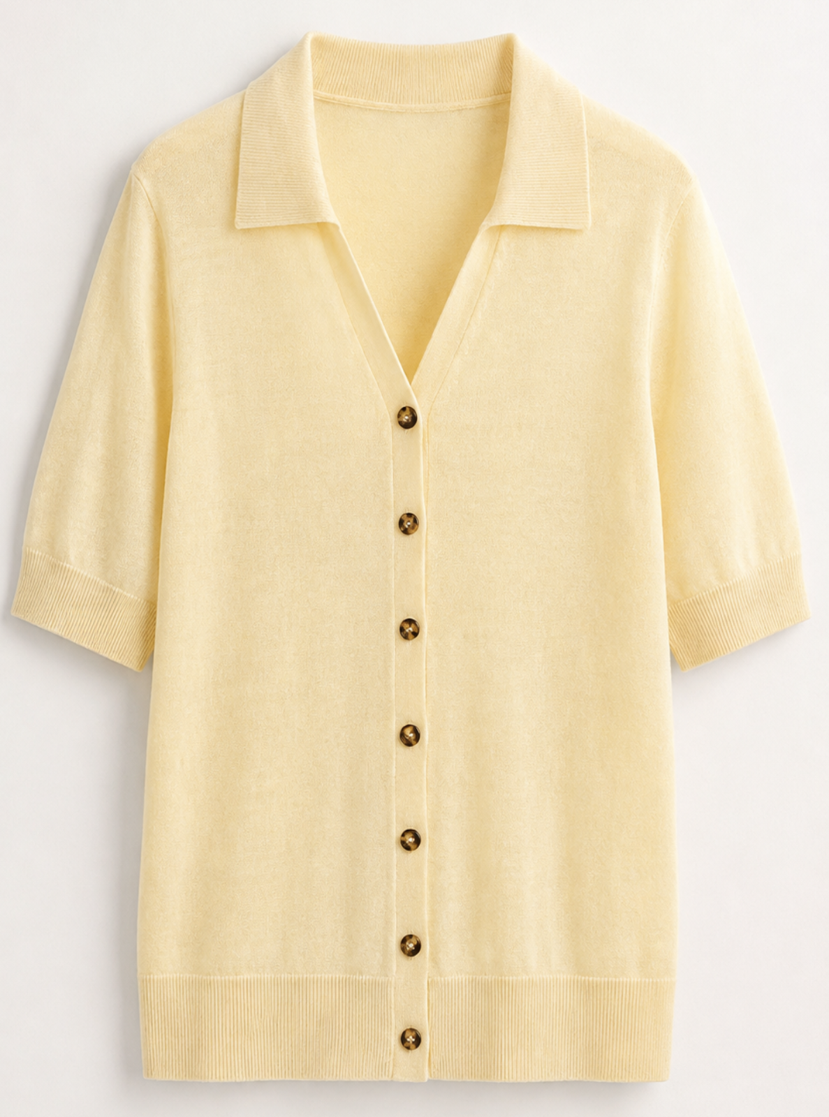 A pale yellow short-sleeve knit polo cardigan with brown buttons, displayed flat against a light off-white background.