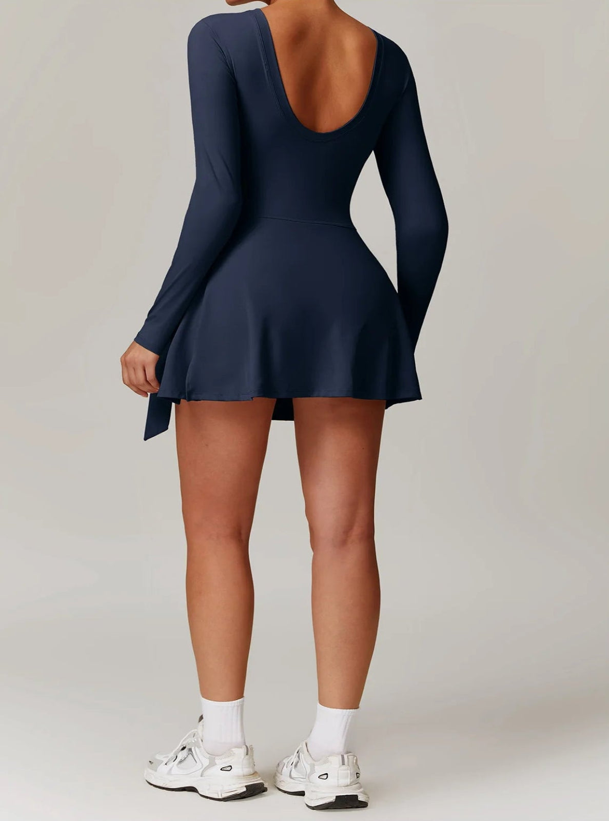 Navy blue dress worn by a person on a plain background
