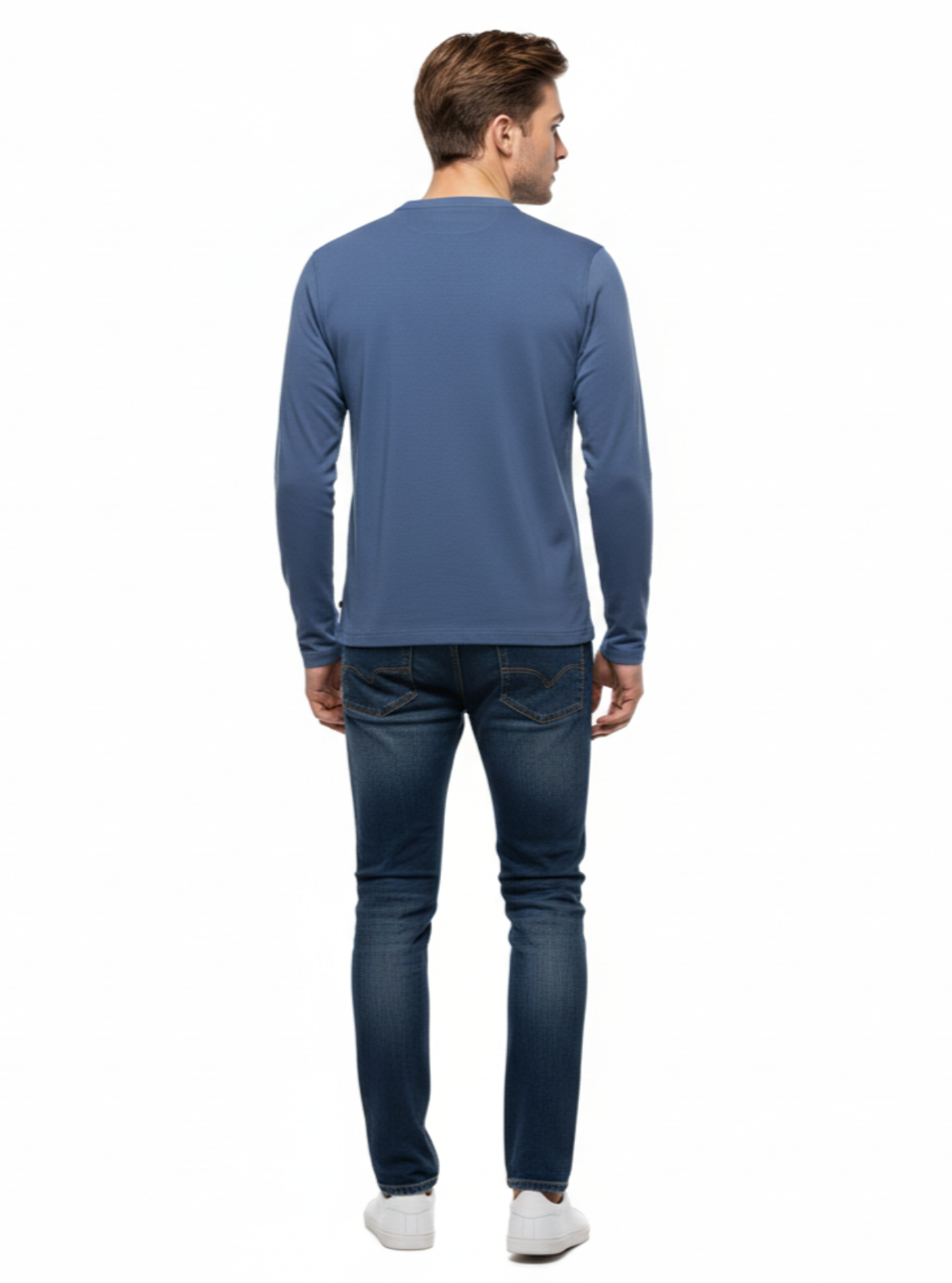Man wearing a blue long-sleeve shirt and jeans on a white background
