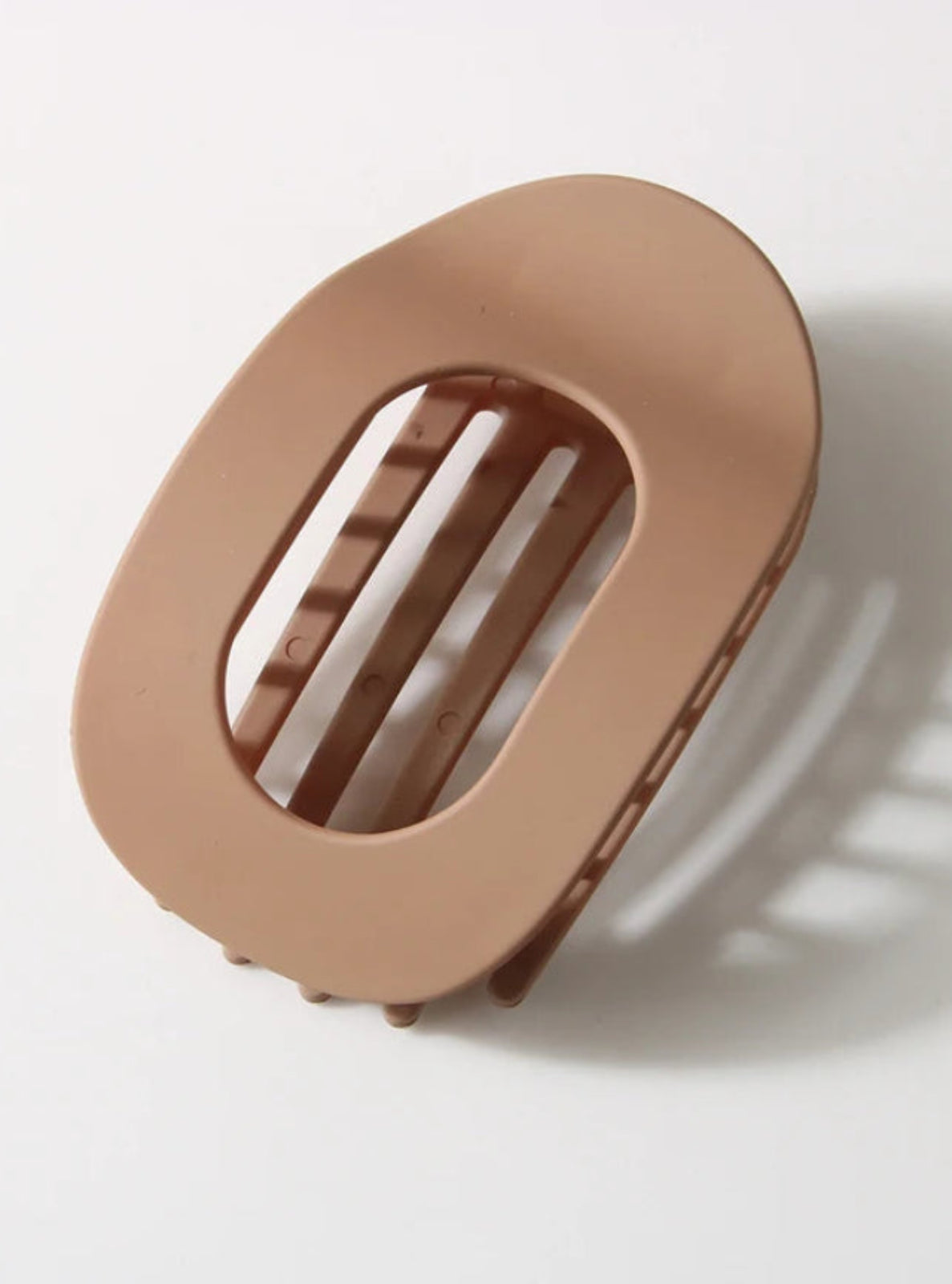 Beige hair clip on a white background