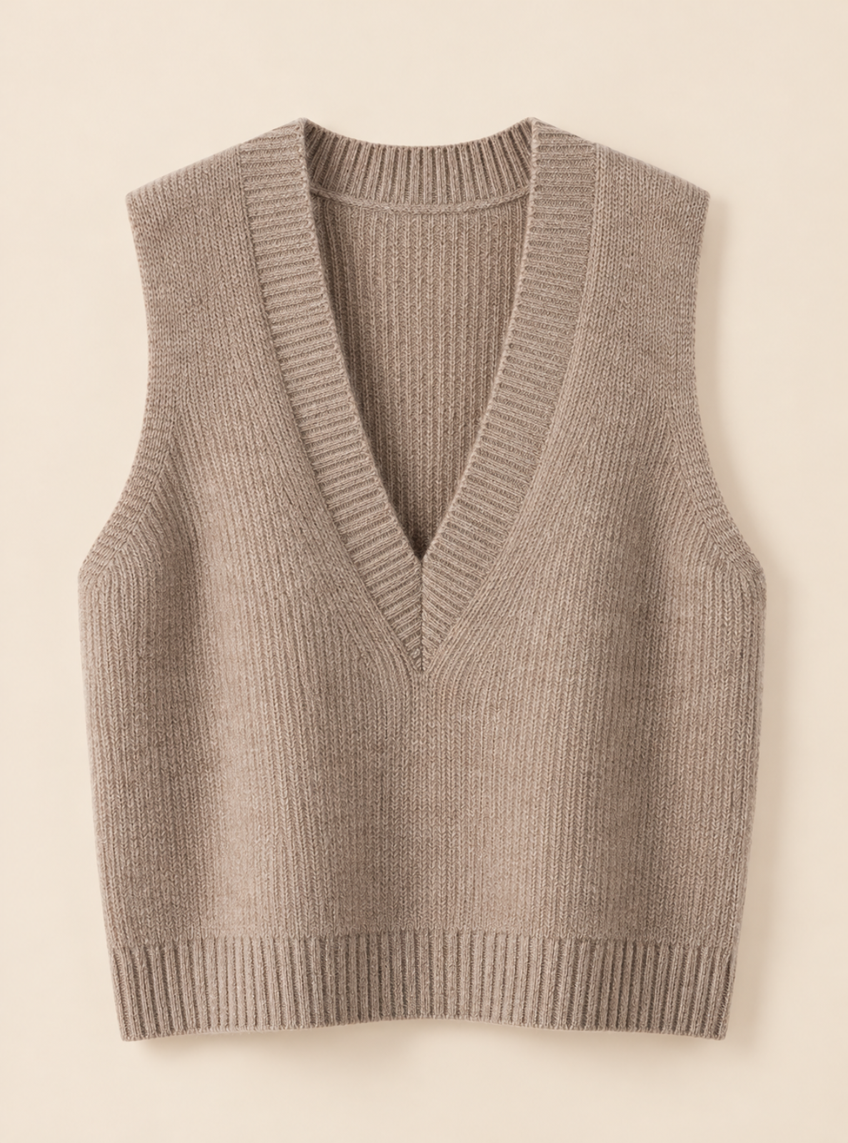 A sleeveless ribbed knit vest in a taupe-beige color, featuring a V-neckline and ribbed trim at the collar, armholes, and hem, shown against a solid cream background.