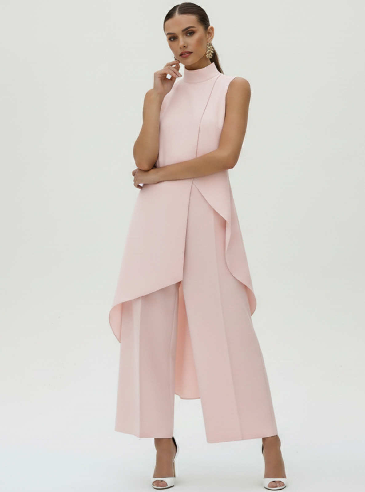 Woman wearing a pink dress with a white background