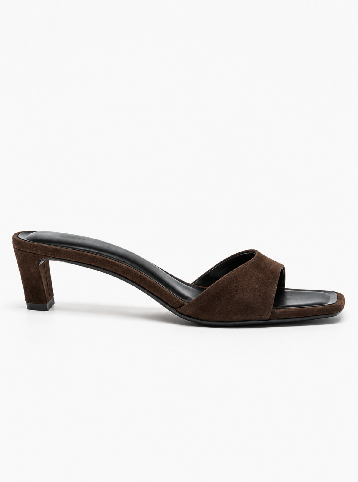 A dark brown suede slide sandal with a low block heel and a single wide strap, shown from a side profile on a light gray background.