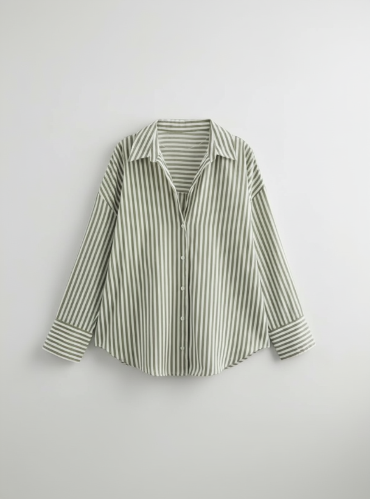Green and white striped shirt on a light gray background