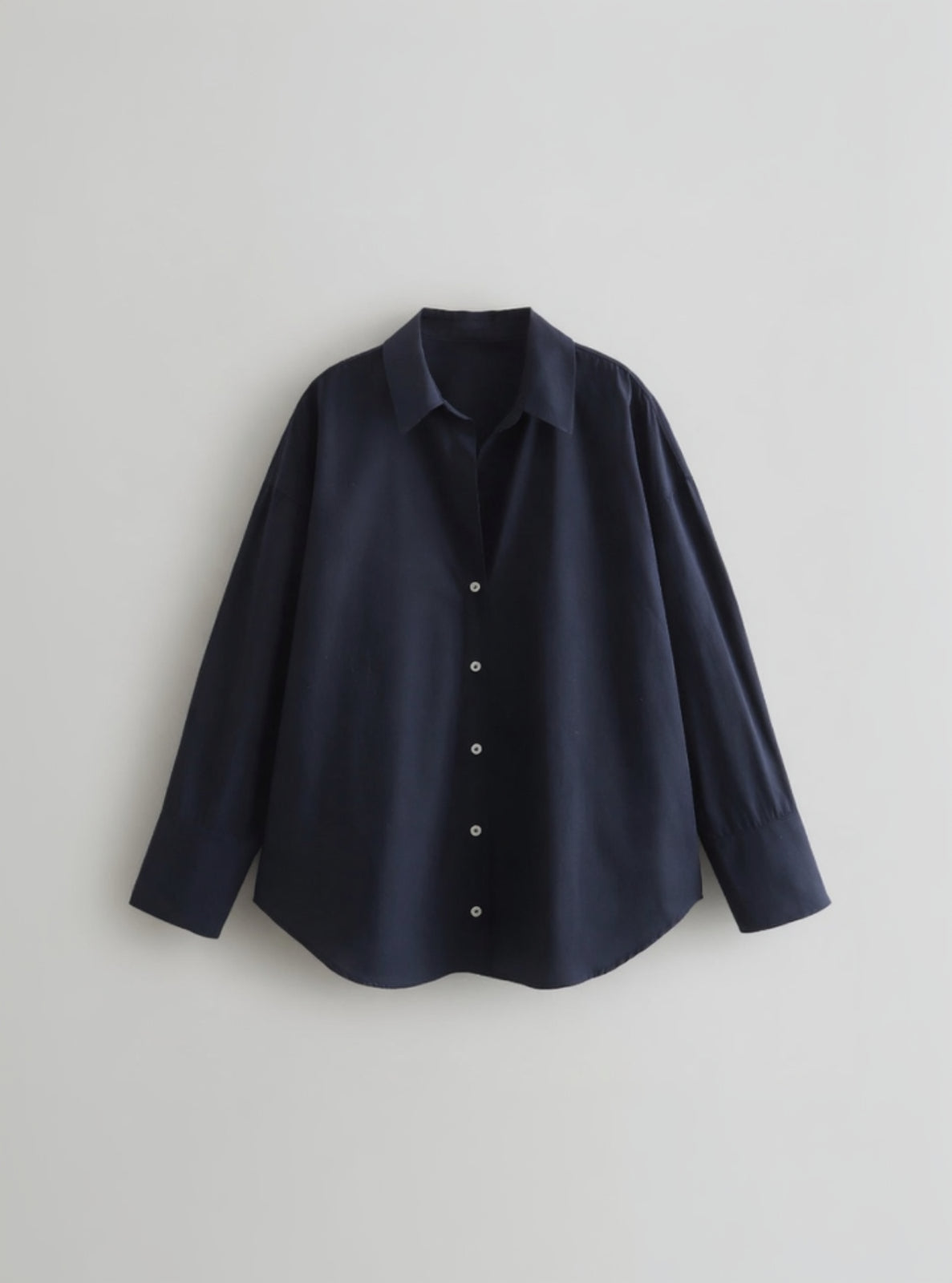 Navy blue shirt on a light gray background