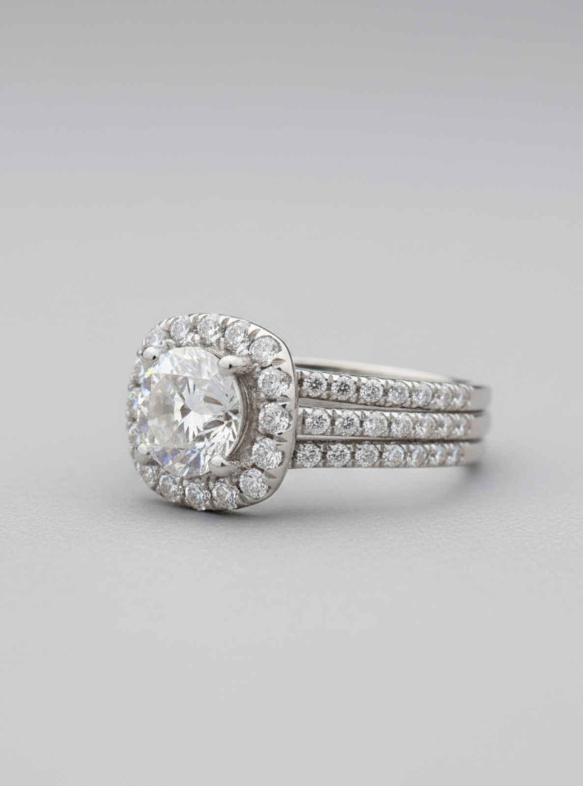 Diamond ring with a halo setting on a gray background