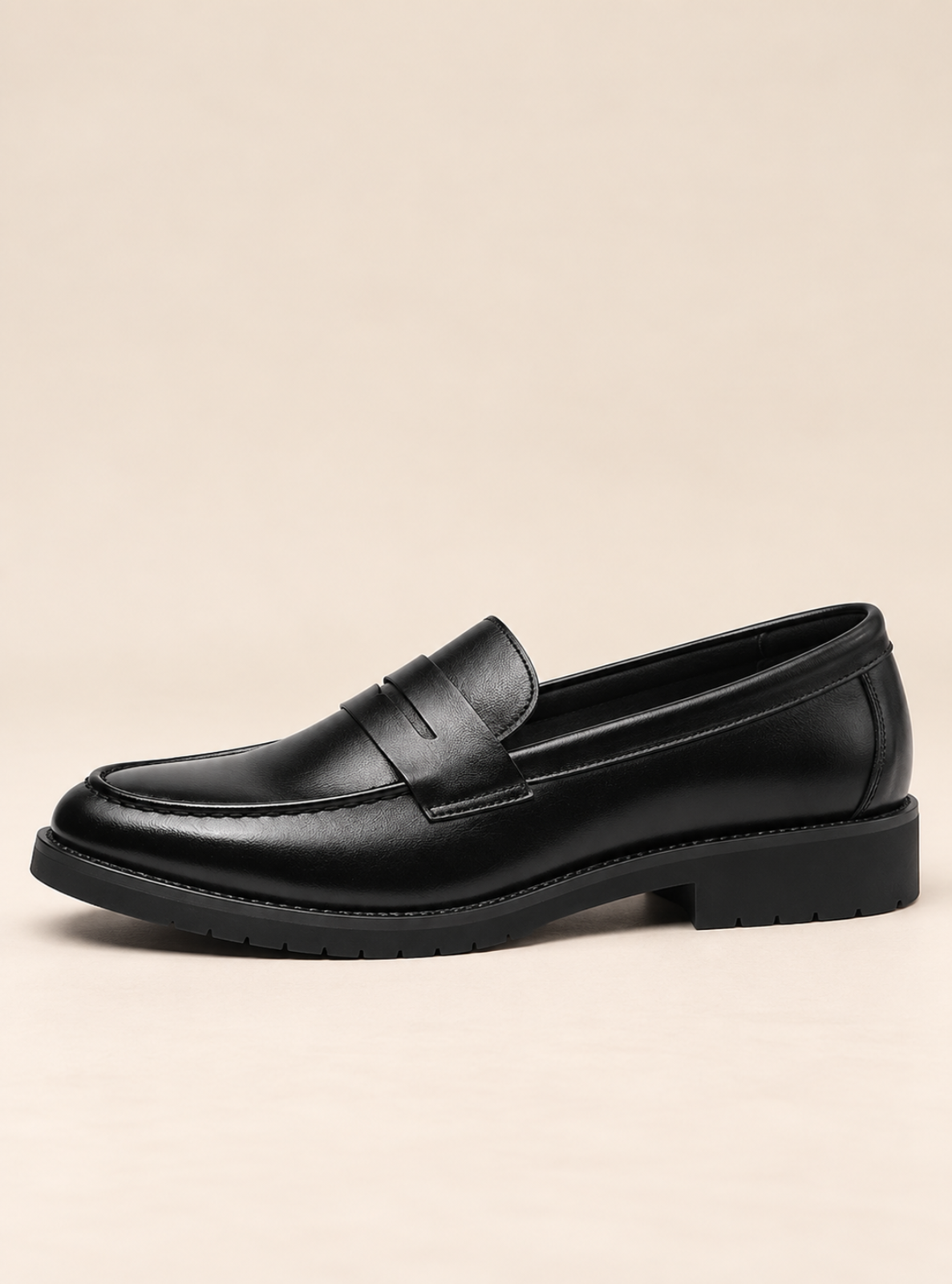 A pair of black leather lace-up shoes with a chunky black sole, displayed on a clean white studio background.