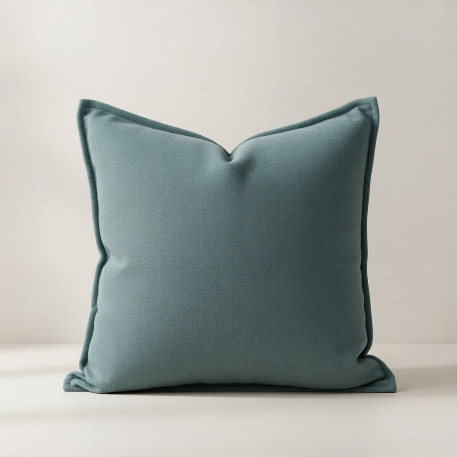 Teal pillow on a light background