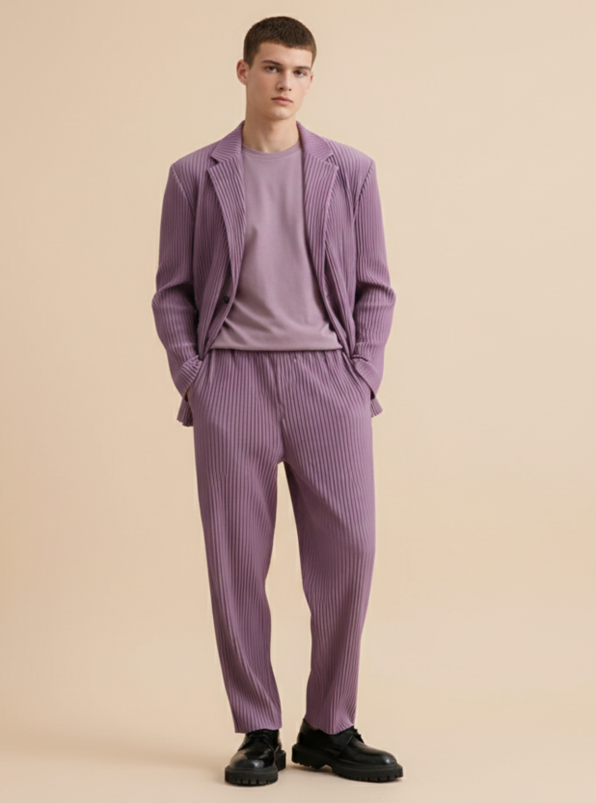 Man wearing a purple suit standing against a beige background