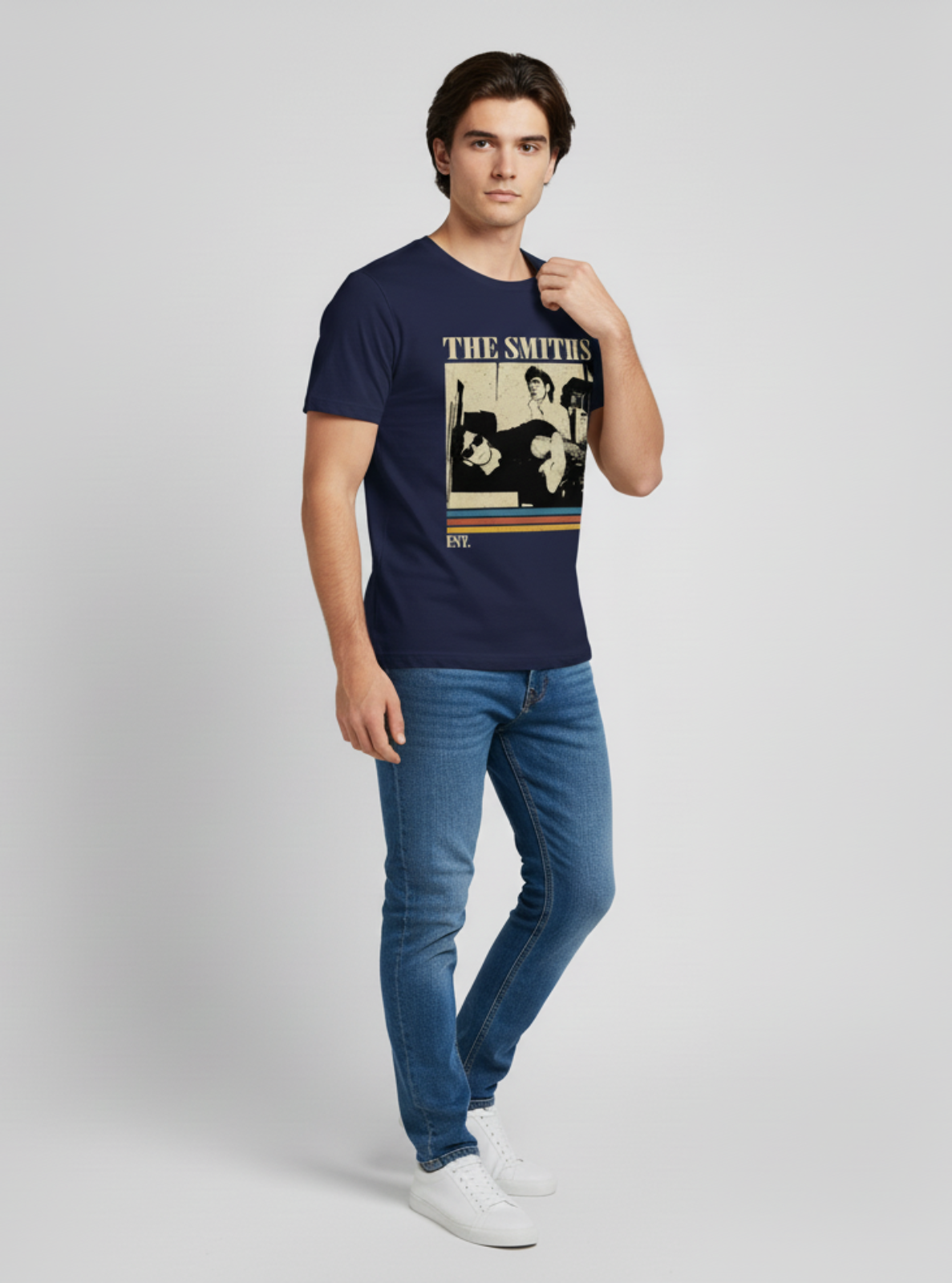 Man wearing a navy blue t-shirt with 'The Smiths' graphic design on a light gray background