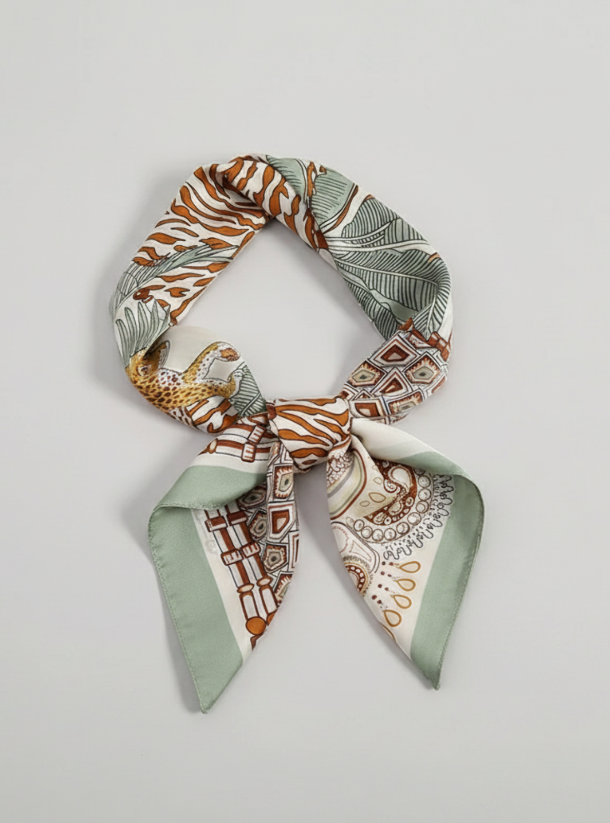 Patterned scarf tied into a knot on a light gray background