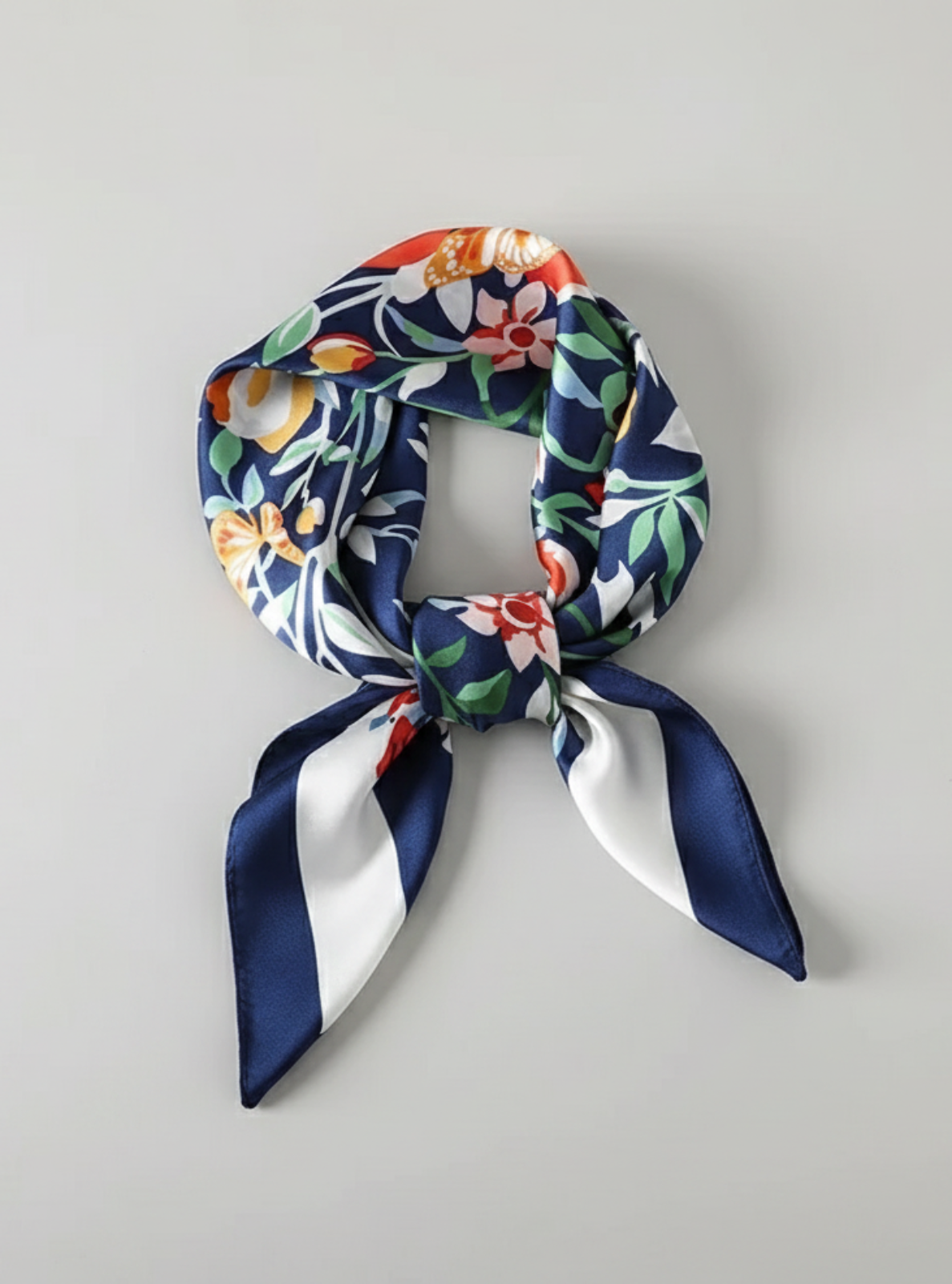 Floral and navy blue scarf on a light gray background
