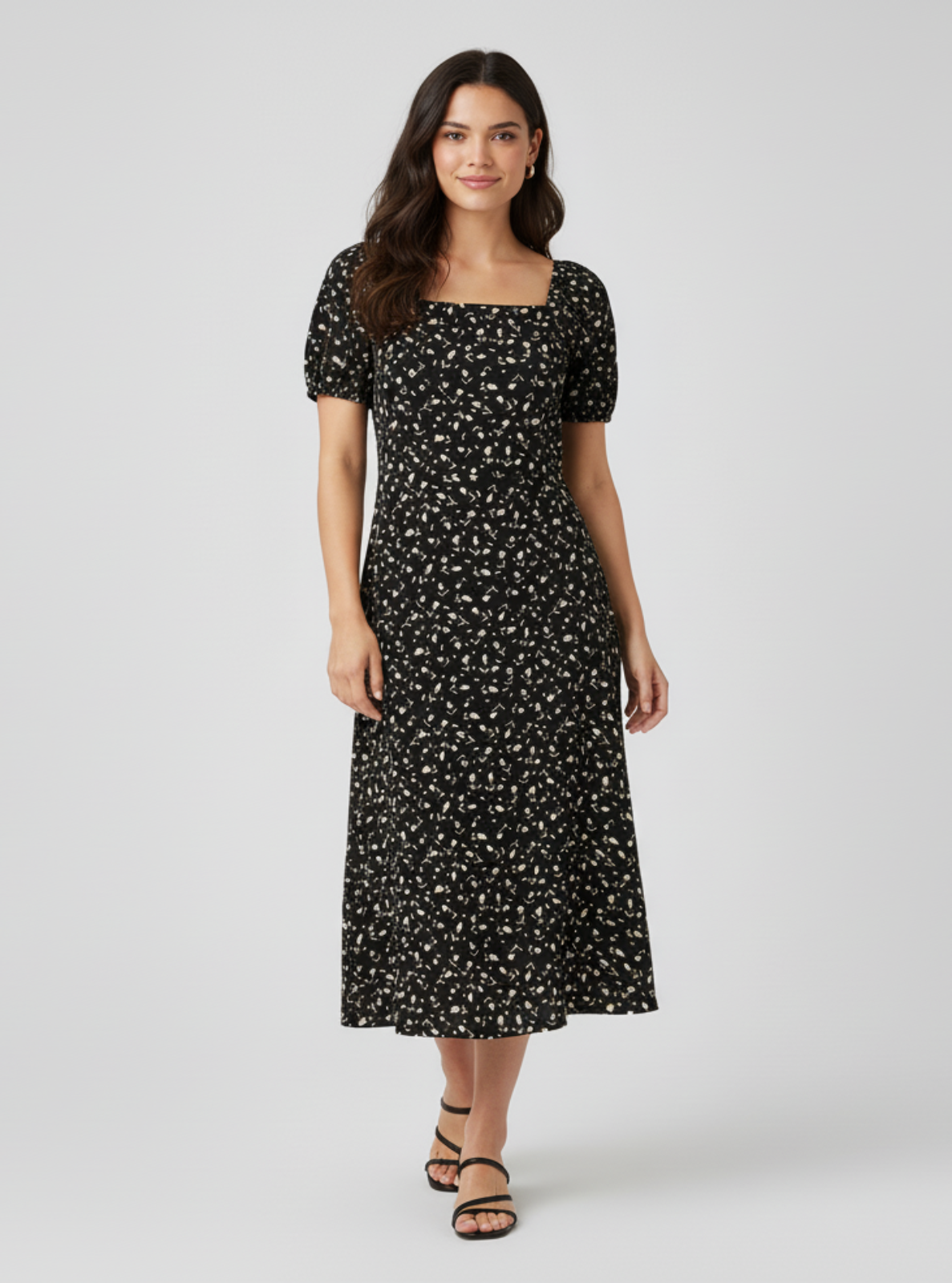 Woman wearing a black floral dress on a white background