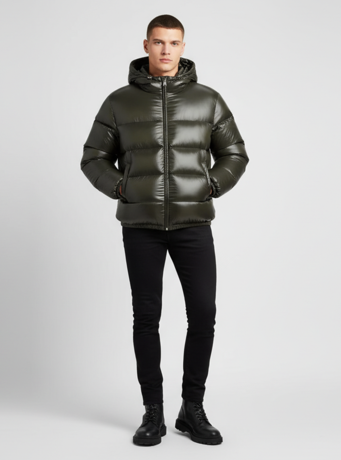 Man wearing a green puffer jacket on a gray background